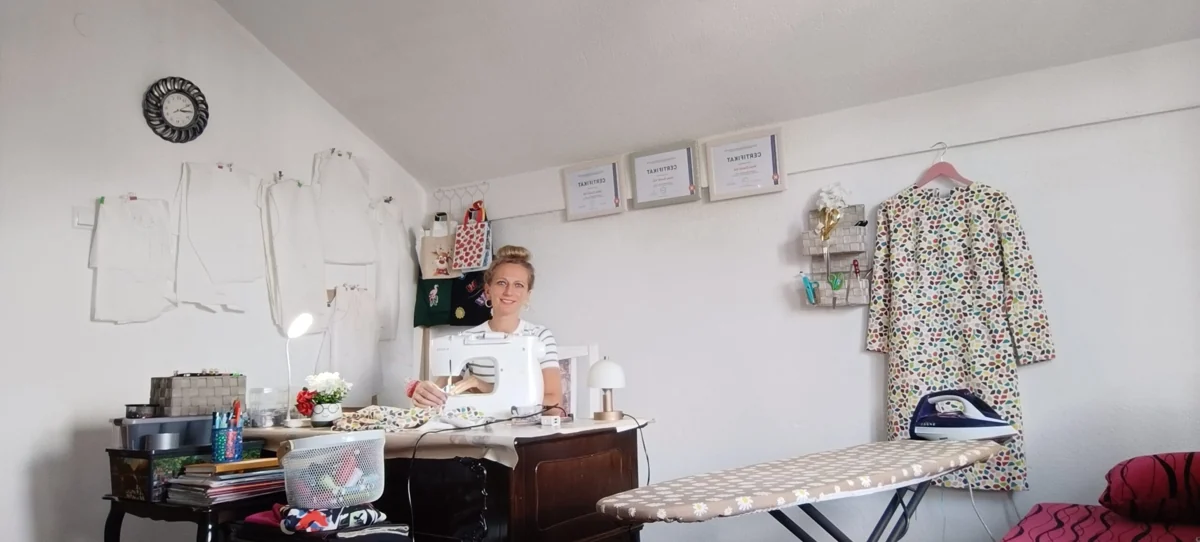 Alena Vuk at a sewing machine in a workshop