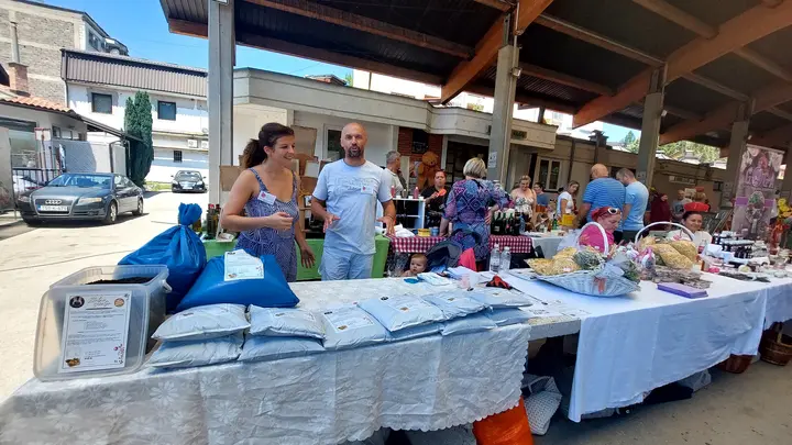 People presenting products at a market stall