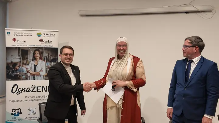 People shaking hands at an EmpowerHER project event